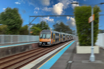 Passenger Train going through Lewisham Train Station at Sunset a suburban Sydney train Station in Sydney NSW Australia © Elias Bitar