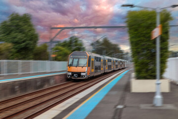 Passenger Train going through Lewisham Train Station at Sunset a suburban Sydney train Station in Sydney NSW Australia © Elias Bitar