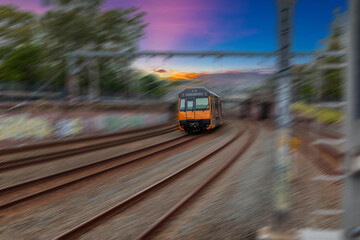 Passenger Train going through Lewisham Train Station at Sunset a suburban Sydney train Station in Sydney NSW Australia © Elias Bitar