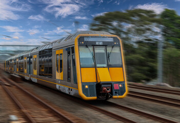 Fototapeta premium Passenger Train going through Lewisham Train Station at Sunset a suburban Sydney train Station in Sydney NSW Australia
