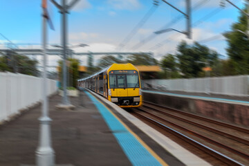 Obraz premium Passenger Train going through Lewisham Train Station at Sunset a suburban Sydney train Station in Sydney NSW Australia