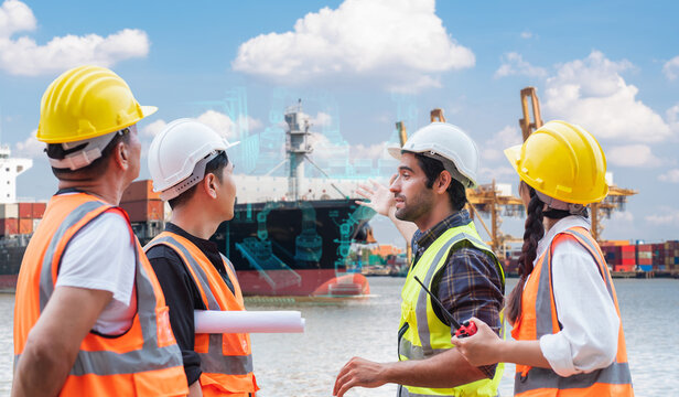 Group of engineers discussing smart logistics with digital hologram at cargo port, composite image, not AI generated.