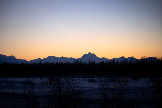 Sunset over mountains and the Delta River
