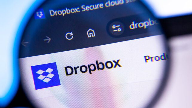 Dropbox logo on computer screen zoomed in using magnifying glass extreme close up.