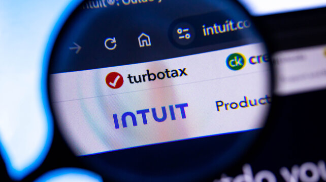 A close-up view of the turbotax website shown on a computer screen through a magnifying glass.