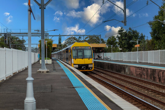 Passenger Train going through Lewisham Train Station at Sunset a suburban Sydney train Station in Sydney NSW Australia
