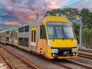 Obraz premium Passenger Train going through Lewisham Train Station at Sunset a suburban Sydney train Station in Sydney NSW Australia