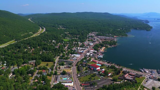 Town of Lake George up state north North New York State summer downtown Main Street cars ferry boats street building landscape sunny morning blue sky Adirondack Mountains upwards motion