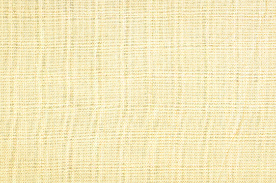 Close up cream beige woven fabric texture background with detailed textile linen canvas pattern for commercial mockup product design