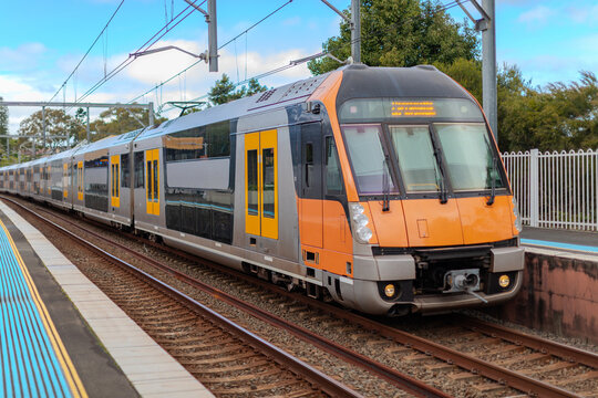 Passenger Train going through Lewisham Train Station at Sunset a suburban Sydney train Station in Sydney NSW Australia