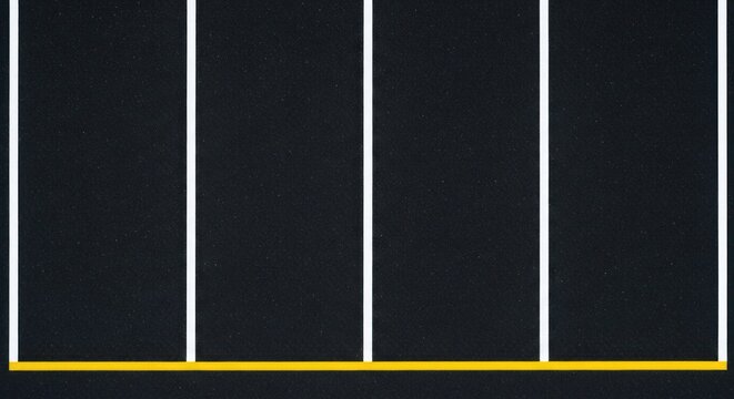 Top view of empty asphalt parking lot with white lines.
