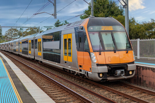 Passenger Train going through Lewisham Train Station at Sunset a suburban Sydney train Station in Sydney NSW Australia