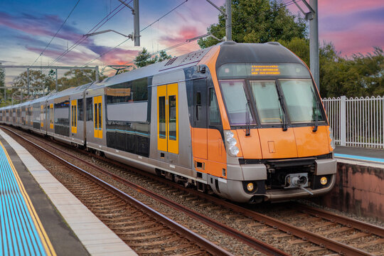 Passenger Train going through Lewisham Train Station at Sunset a suburban Sydney train Station in Sydney NSW Australia