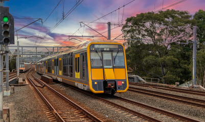 Obraz premium Passenger Train going through Lewisham Train Station at Sunset a suburban Sydney train Station in Sydney NSW Australia