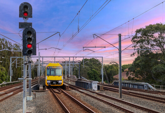 Passenger Train going through Lewisham Train Station at Sunset a suburban Sydney train Station in Sydney NSW Australia