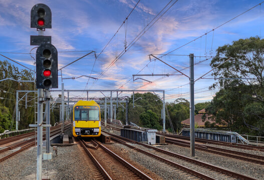 Passenger Train going through Lewisham Train Station at Sunset a suburban Sydney train Station in Sydney NSW Australia