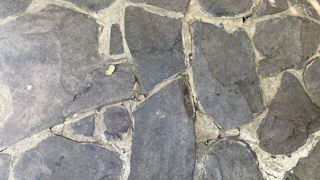 Rustic dark stone floor paving texture with cracks
