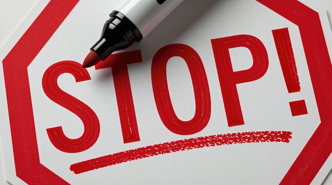 Bold red word STOP written with marker pen on white surface. Handwritten text with exclamation point conveys warning message. Graphic design concept features vibrant ink stroke. Simple minimalist