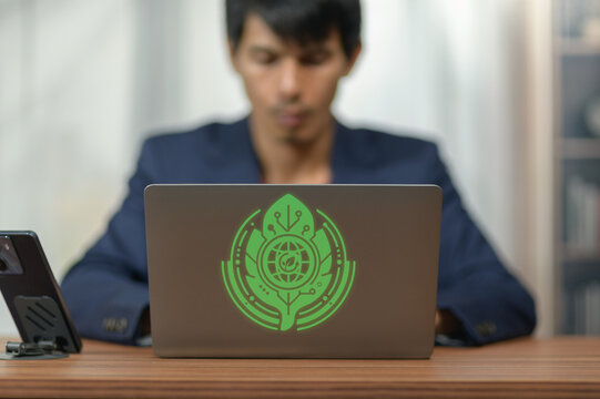 Young Man Working on Laptop with Digital Security and Technology Graphic