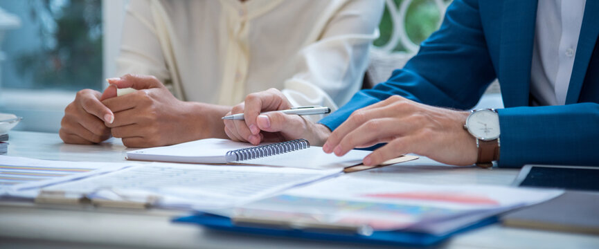 Banner Two Businessman signing contract document dealing teamwork. Banner Close up hand man colleagues  meeting mergers and acquisitions business. Partners Signed document at office with copy space