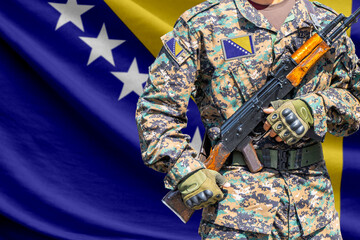 Fototapeta premium Bosnia and Herzegovina flag with soldier holding assault rifle