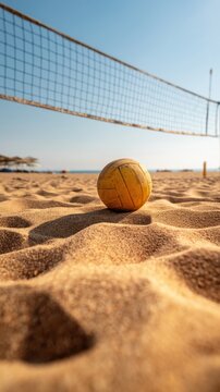 Volleyball resting on rippled sand at beach volleyball court