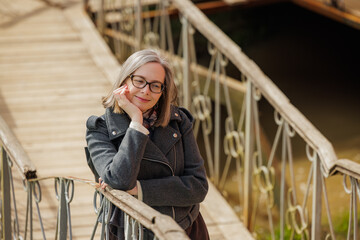Fototapeta premium Enjoying a peaceful moment on a charming wooden bridge during the golden hour