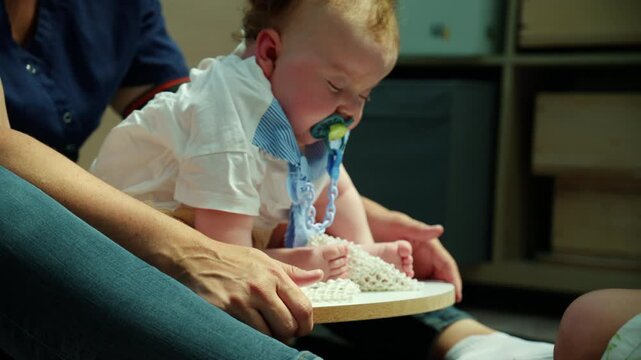 Medical professional comforting a crying baby with a pacifier during a health checkup or pediatric care visit