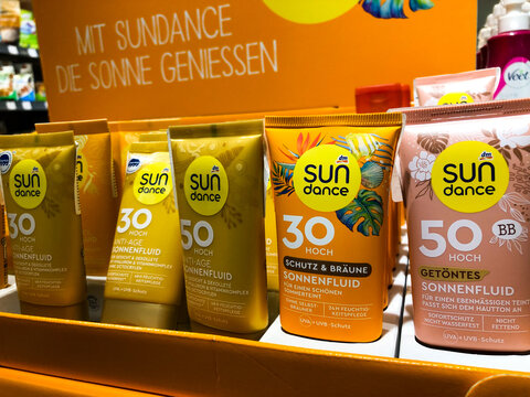 Varna, Bulgaria - May 11, 2026: DM SPF sun skin, hair protection creams and balms. Sunburn protection. Tan solar fluid. Sun care products displayed on shelf, various SPF levels and packaging visible