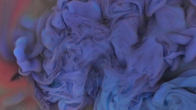 Abstract fluid ink art with translucent blue and faint cold tone pigment swirling in water