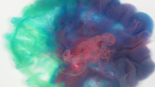 Abstract ink diffusion art with gradient red, green and blue pigment in clear water