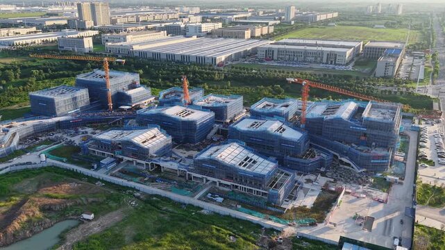 Aerial View of Building Construction Site with Tower Cranes and Scaffolding