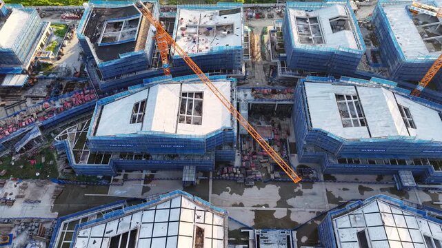 Aerial View of Building Construction Site with Tower Cranes and Scaffolding