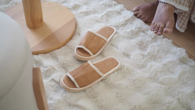 Walking on a soft rug with slippers at home
