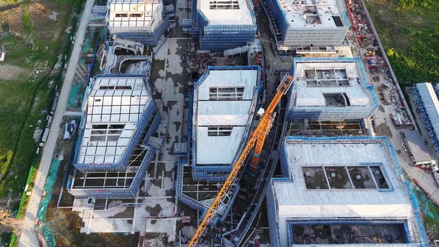 Aerial View of Building Construction Site with Tower Cranes and Scaffolding
