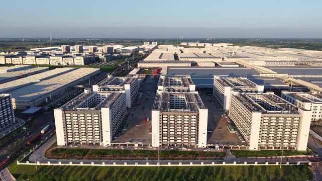 Aerial wide view of modern industrial park with factory buildings and staff dormitories
