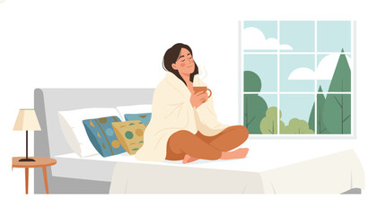 Obraz premium Content woman sits comfortably on her bed wrapped in a warm blanket while holding a steaming mug and looking out the window.