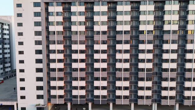 Facade of modern staff dormitory building with repetitive window and balcony structure