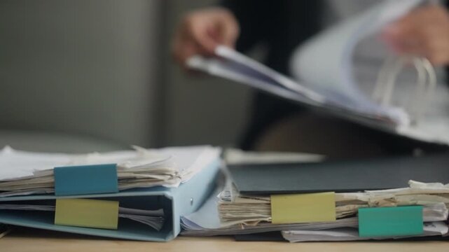 Stack of Business Document Files and Office Paperwork Ready for Organization and Review