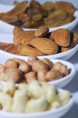 Fototapeta premium dried fruits and nuts on white spoons isolated on white background 