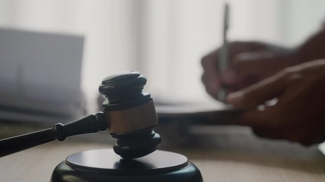 Signing Legal Documents with Judge&rsquo;s Gavel in Law Office for Contract and Compliance