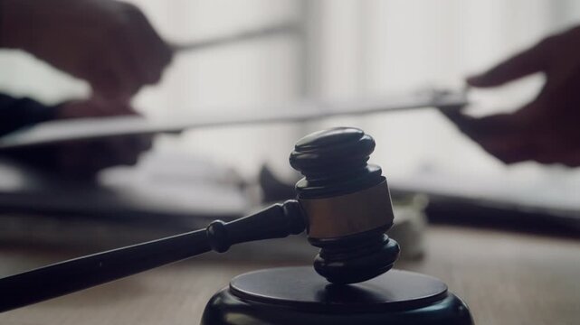 Client Signing Legal Agreement with Judge&rsquo;s Gavel in Law Office Consultation