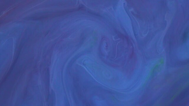 Abstract fluid ink art with translucent blue and faint cold tone pigment swirling in water