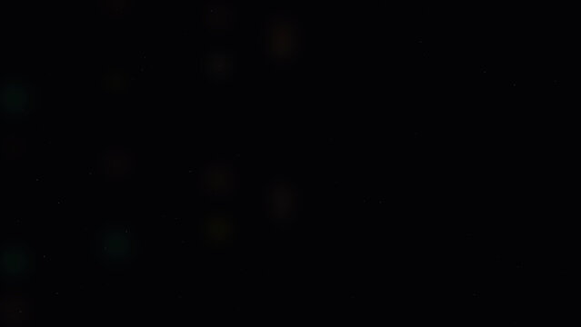 Abstract dark background with soft glowing bokeh light particles floating