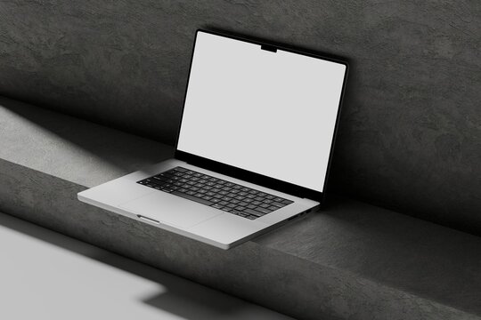 Showcase your digital designs with this modern laptop mockup featuring a blank white screen in a minimalist dark concrete interior.