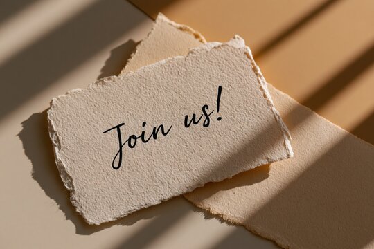Cream paper card displaying Join us! text on beige, with warm sunlight and shadows