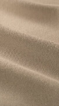 Soft beige fabric texture with elegant draped folds