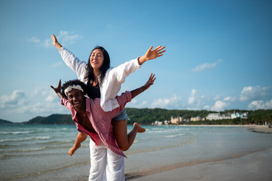Pure happiness. A young diverse, multiethnic couple enjoys every moment of their tropical getaway