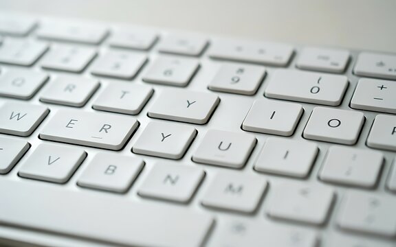 A close-up view of a clean white keyboard featuring clearly labeled alphanumeric keys and function keys