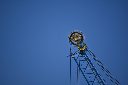 A ferris wheel on blue sky background during summertime in Italy